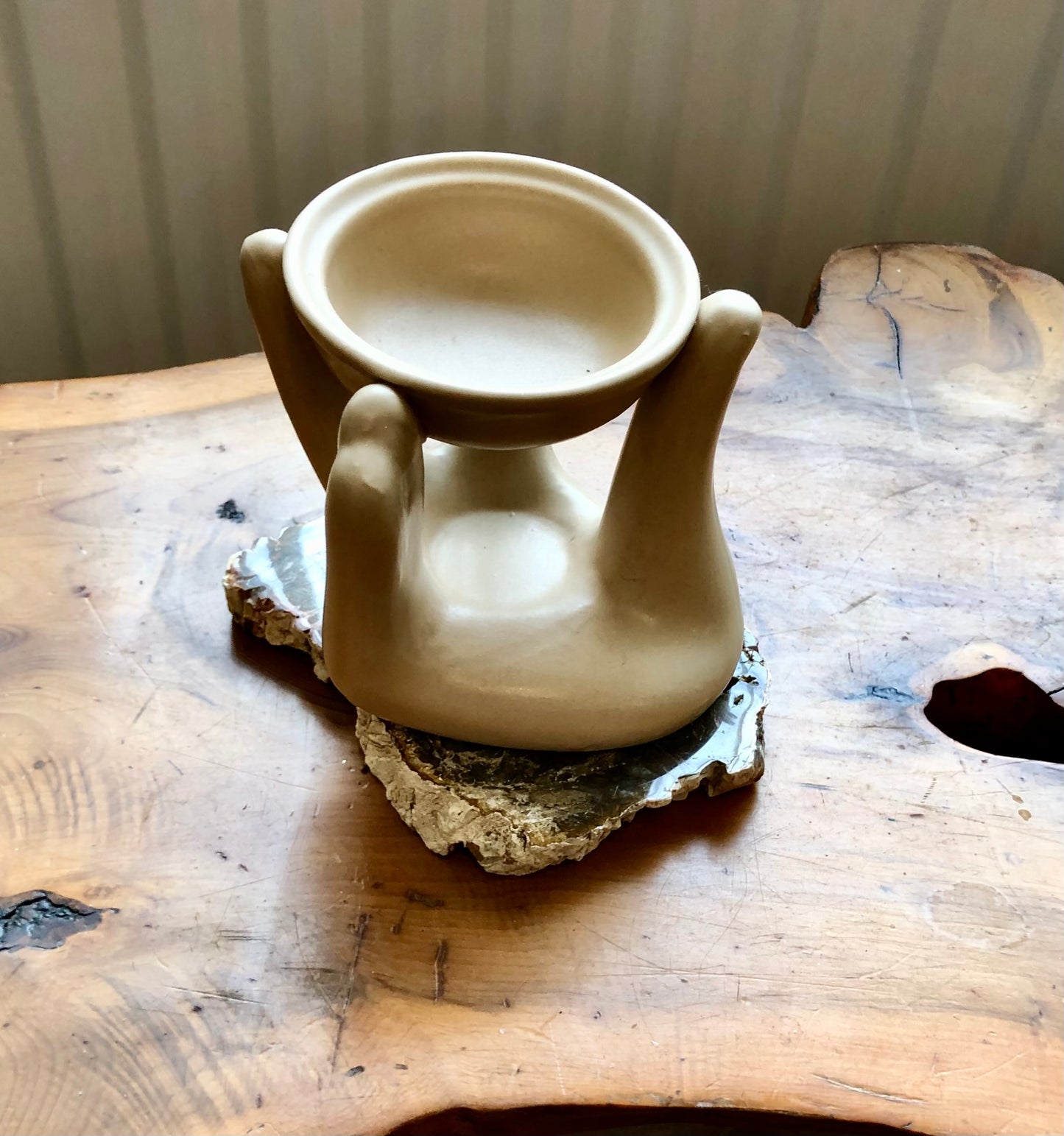 Elegant little hand-shaped oil burner.