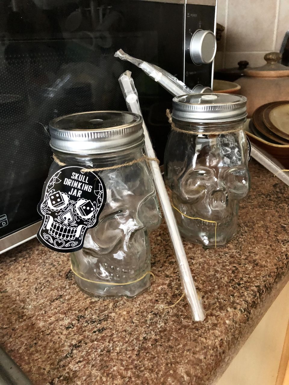 Three glass skull drinking jars.