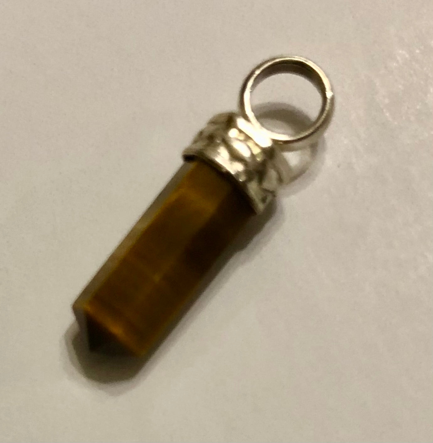 Tiger Eye and Silver Chrystal Point. Tiny (half an inch/7.62 cm long).