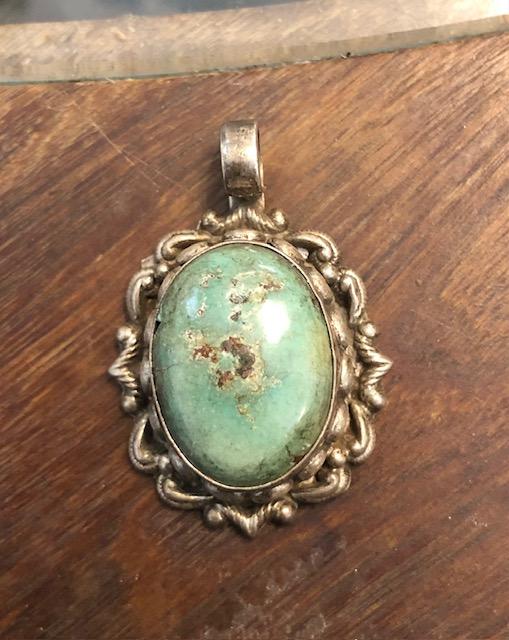 Turquoise and aged silver pendant.